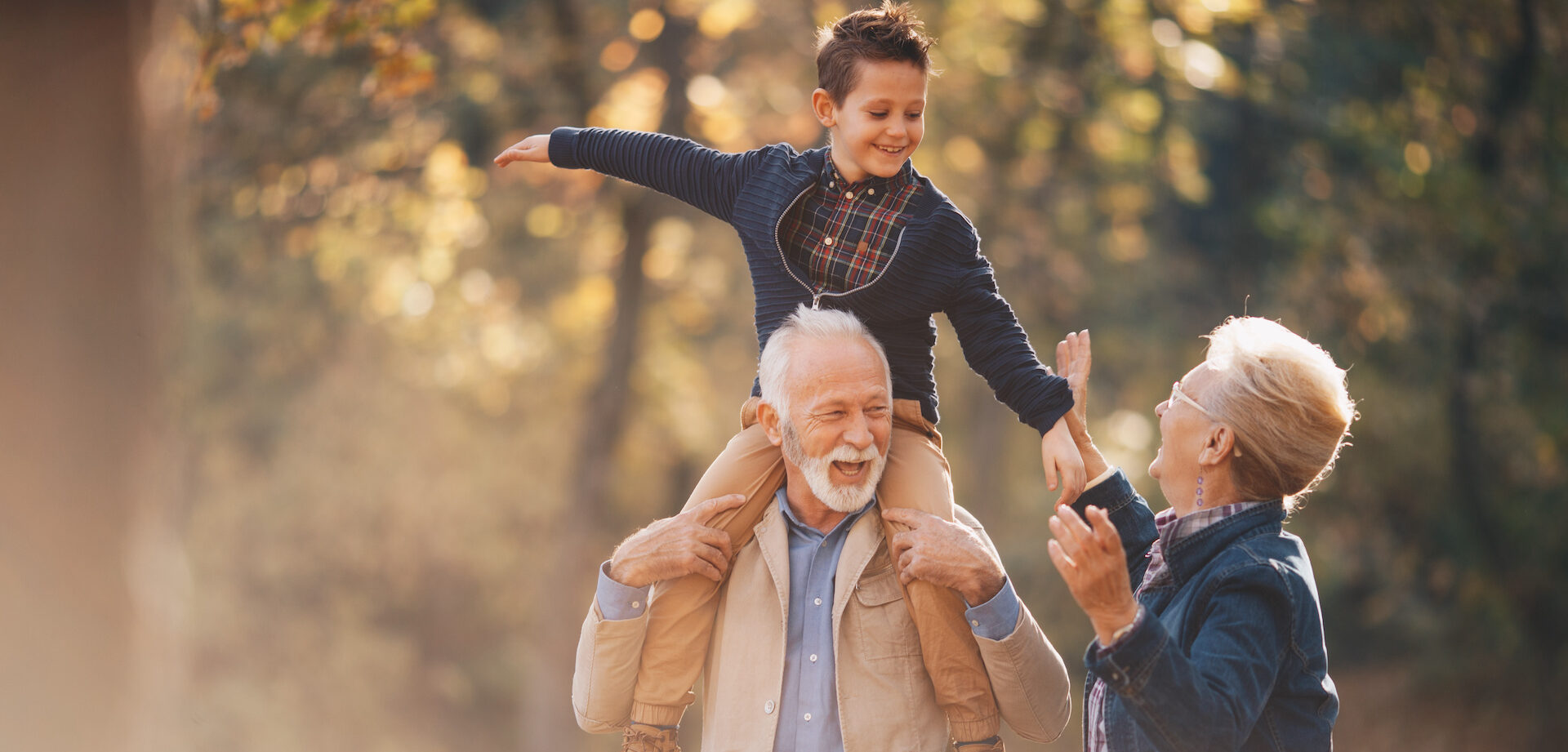 elderly couple walking with grandson